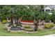 Stone entrance to Carolina Orchards with water feature and decorative water wheel at 238 Cherrytree Dr, Fort Mill, SC 29715