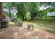 The concrete back patio has an outdoor grill and table with chairs and a fire pit at 2418 Live Oak Ct, Gastonia, NC 28056