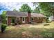 A fully fenced backyard features a brick house with a patio at 2418 Live Oak Ct, Gastonia, NC 28056