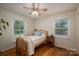 Cozy bedroom with hardwood floors, neutral paint, a ceiling fan, and bright natural lighting at 2418 Live Oak Ct, Gastonia, NC 28056