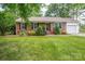 Charming brick home with a well-manicured front lawn and mature landscaping at 2418 Live Oak Ct, Gastonia, NC 28056