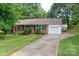 Charming brick home featuring a well-manicured lawn and an attached one-car garage at 2418 Live Oak Ct, Gastonia, NC 28056