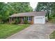 Charming brick home featuring a well-manicured lawn and an attached one-car garage at 2418 Live Oak Ct, Gastonia, NC 28056