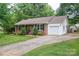 Charming brick home featuring a well-manicured lawn and an attached one-car garage at 2418 Live Oak Ct, Gastonia, NC 28056