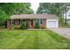 Charming brick home with a lush green lawn and a well-maintained landscape, offering great curb appeal at 2418 Live Oak Ct, Gastonia, NC 28056