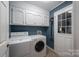 Laundry room with washer, dryer, white cabinets, utility sink, and access door at 2418 Live Oak Ct, Gastonia, NC 28056