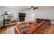 Bright living room boasts exposed brick fireplace, ceiling fan, hardwood floors, and stylish furnishings at 2418 Live Oak Ct, Gastonia, NC 28056