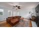 Inviting living area featuring hardwood floors, a ceiling fan, and a comfortable leather sofa at 2418 Live Oak Ct, Gastonia, NC 28056