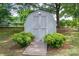 Backyard shed providing ample storage space with a wooden ramp and surrounding bushes at 2418 Live Oak Ct, Gastonia, NC 28056