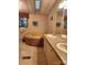 Retro bathroom with a carpeted platform tub and double sink vanity at 2461 Ridgecrest Dr, Stanley, NC 28164