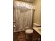 Bathroom featuring a floral-patterned shower curtain with a standard toilet and sink at 2461 Ridgecrest Dr, Stanley, NC 28164