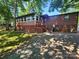 Rear exterior view of a single-story home with a lattice-skirted porch and a small yard at 2461 Ridgecrest Dr, Stanley, NC 28164
