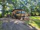 Exterior view of a house with a brown exterior, green shutters, and a small storage shed at 2461 Ridgecrest Dr, Stanley, NC 28164
