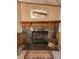 Stone fireplace with wood mantel, glass doors, and a hearth rug creates a warm focal point at 2461 Ridgecrest Dr, Stanley, NC 28164