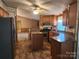 Open kitchen with functional island, flowing into a dining area and living room at 2461 Ridgecrest Dr, Stanley, NC 28164