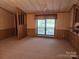 Spacious living room features a large window with natural light and neutral carpeting at 2461 Ridgecrest Dr, Stanley, NC 28164