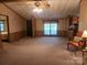 Cozy living room with comfortable chair, neutral carpeting, and natural light from a window at 2461 Ridgecrest Dr, Stanley, NC 28164