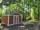 Outdoor storage shed for tools and equipment is nestled in the trees at 2461 Ridgecrest Dr, Stanley, NC 28164