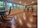 A spacious sunroom featuring hardwood floors and multiple windows at 2461 Ridgecrest Dr, Stanley, NC 28164