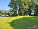 Large front yard with mature trees and a well-maintained lawn, neighborhood location at 2461 Ridgecrest Dr, Stanley, NC 28164