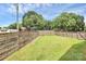 Spacious fenced backyard with lush green grass, offering privacy and outdoor space at 2600 Palm Ave, Charlotte, NC 28205