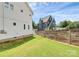 Fenced backyard with trees and lawn offering privacy, landscaping and curb appeal at 2600 Palm Ave, Charlotte, NC 28205
