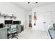 White bedroom featuring a gray desk, hanging guitar, and white closets at 2600 Palm Ave, Charlotte, NC 28205