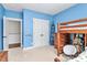 Neutral carpeted bedroom featuring a bunk bed, white closets, and blue accent decorations at 2600 Palm Ave, Charlotte, NC 28205
