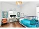 Bedroom featuring hardwood floors, two windows, and a blue bed frame at 2600 Palm Ave, Charlotte, NC 28205