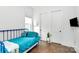 Cozy bedroom with blue metal bed frame, wood floors, and neutral walls and trim at 2600 Palm Ave, Charlotte, NC 28205