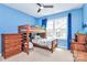 Blue bedroom with a wooden bunk bed, natural light, and neutral carpet flooring at 2600 Palm Ave, Charlotte, NC 28205