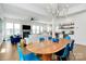 Open-concept dining room features a wooden dining table set, adjacent to a living area with a fireplace at 2600 Palm Ave, Charlotte, NC 28205