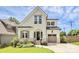 Beautiful two-story home featuring a landscaped yard, brick accents, and a welcoming arched entryway and modern curb appeal at 2600 Palm Ave, Charlotte, NC 28205