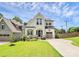 Charming two-story home with manicured lawn and a modern architectural design under a bright blue sky at 2600 Palm Ave, Charlotte, NC 28205