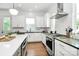 Contemporary kitchen with stainless steel appliances, white cabinets, and an open design for entertaining with modern appliances at 2600 Palm Ave, Charlotte, NC 28205