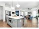 Open concept kitchen featuring a center island, stainless steel appliances, and easy access to the living room at 2600 Palm Ave, Charlotte, NC 28205