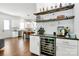 Wet bar features a wine cooler and open shelves for glassware and bottles at 2600 Palm Ave, Charlotte, NC 28205