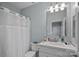 Bright bathroom featuring a white vanity, framed mirror and shower/tub combination at 2625 E 5Th St # F, Charlotte, NC 28204