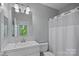 Bright bathroom featuring a white vanity, framed mirror and shower/tub combination at 2625 E 5Th St # F, Charlotte, NC 28204