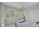 Bedroom features a large arched window providing natural light, plush carpet, and double closet doors at 2625 E 5Th St # F, Charlotte, NC 28204