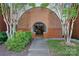Inviting entryway featuring a unique brick archway and well-maintained landscaping at 2625 E 5Th St # F, Charlotte, NC 28204
