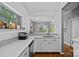 Bright kitchen with modern appliances and white countertops and a window with backyard views at 2625 E 5Th St # F, Charlotte, NC 28204