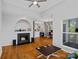 Open living area with hardwood floors, a fireplace, and seamless flow to the kitchen and office at 2625 E 5Th St # F, Charlotte, NC 28204