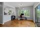 Bright office space with a desk, large windows overlooking trees, and access to kitchen at 2625 E 5Th St # F, Charlotte, NC 28204