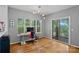 Bright office space with a desk, large windows overlooking trees, and access to a balcony at 2625 E 5Th St # F, Charlotte, NC 28204