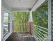 Cozy covered porch with brick supports overlooking a lush green landscape at 2625 E 5Th St # F, Charlotte, NC 28204