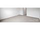 A bright bedroom featuring neutral carpet, white walls, and a convenient entry door at 2656 Goose Fair Rd # 126, Maiden, NC 28650