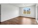 This bedroom features hardwood flooring, natural light and backyard views from a large window at 2656 Goose Fair Rd # 126, Maiden, NC 28650