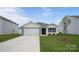 Inviting home featuring an attached garage, well-kept lawn, and attractive landscaping, creating a welcoming curb appeal at 2656 Goose Fair Rd # 126, Maiden, NC 28650