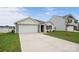 Charming home with a spacious driveway and attached garage, complemented by lush green grass and attractive landscaping at 2656 Goose Fair Rd # 126, Maiden, NC 28650